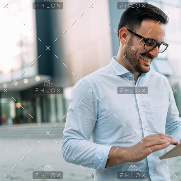 demo-attachment-508-portrait-of-businessman-in-glasses-holding-tablet-AWVHCJU